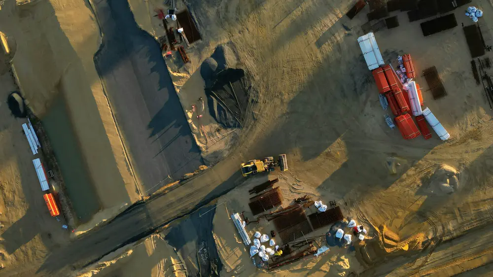 Aerial view of a building site with foundation work