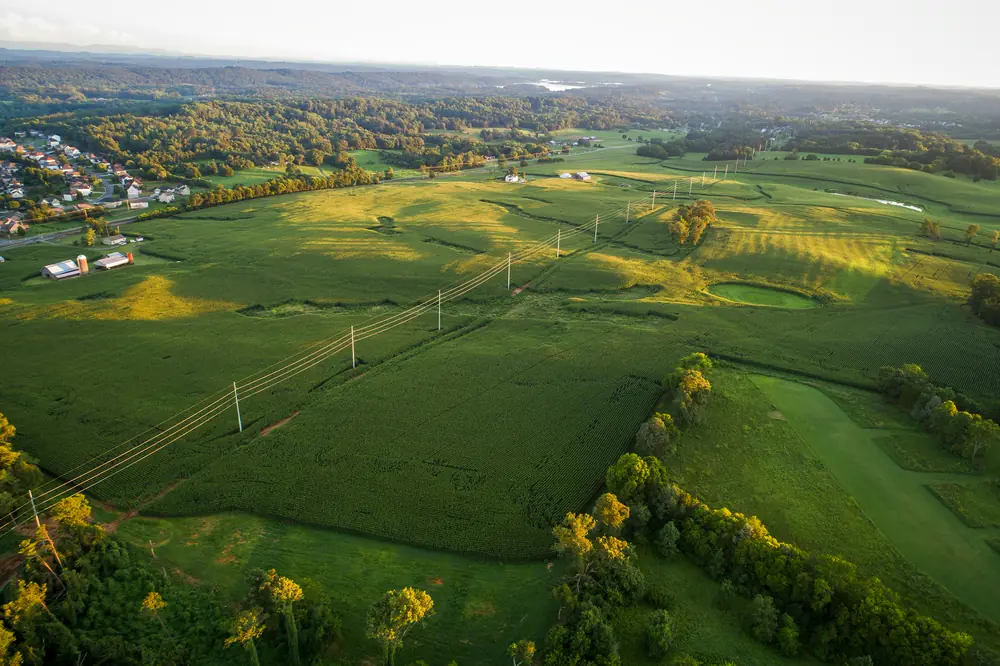 Aerial view of farmland with a power line crossing it