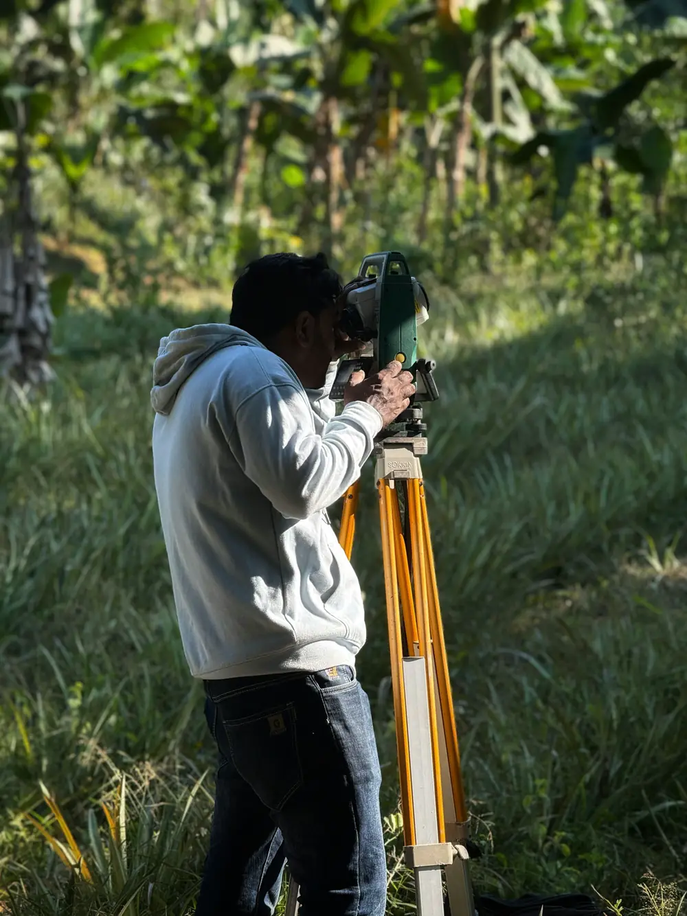 Total station on a tripod in an open field